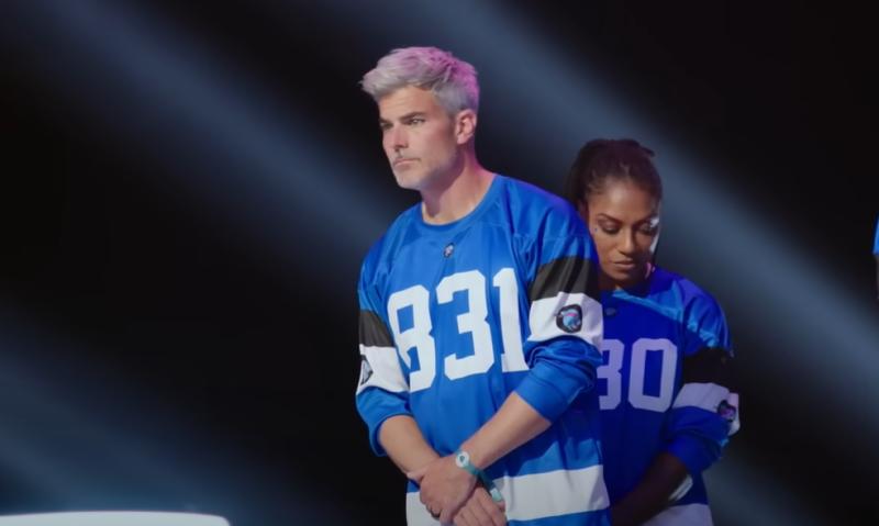 Jeffrey Randall Allen stands in a blue jersey labeled 831 during a tense moment on Beast Games, the Amazon Prime Video competition hosted by MrBeast