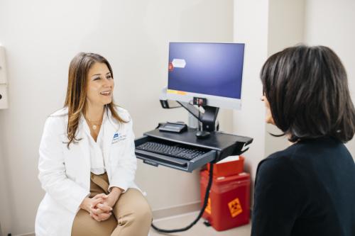Dr. Sanaz Memarzadeh with a patient in a UCLA hospital room.