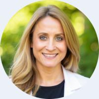 headshot of sonja schrepfer wearing a white lab coat and black top