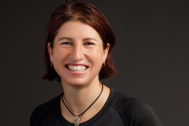 headshot of smiling woman with short brown hair