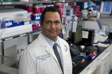 Headshot of Dinesh Rao in lab coat