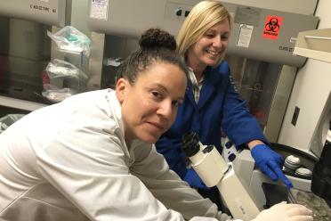 Dr. Joanna Gell (left) and Amander Clark examine germ cell tumor cells in the lab at UCLA.