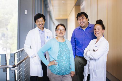 four scientists stand in hallway