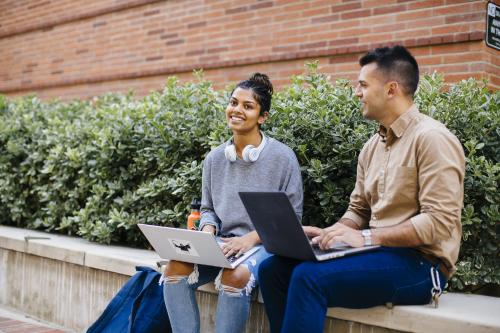 Trainees collaborating and sharing conversation in the courtyard of TLSB