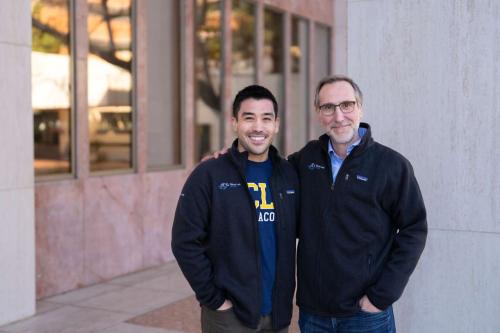 Two UCLA scientists smile together outdoors.