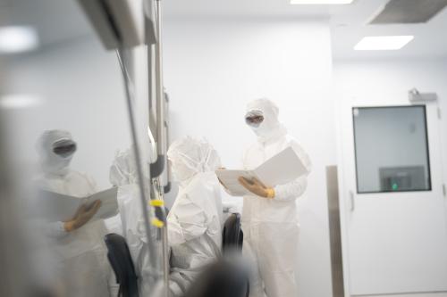 Two scientists covered in PPE work in a UCLA lab.