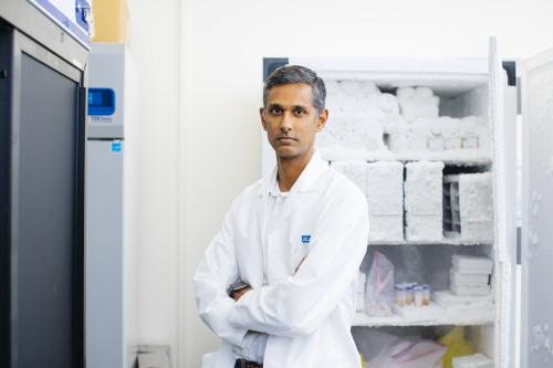 Dr. Ranmal Samarasinghe in his UCLA lab wearing a white coat.