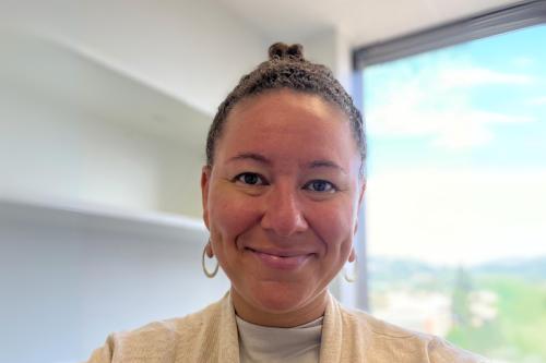 Researcher Tiki Hayes smiles for a headshot in her office