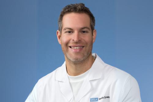 UCLA researcher Avi Samelson smiles for a headshot. 
