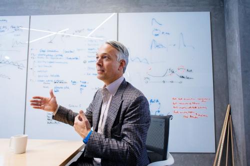 Alexander Hoffman gestures animatedly in a UCLA working space.