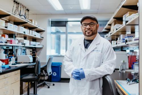Anthony Covarrubias smiles in a UCLA laboratory.