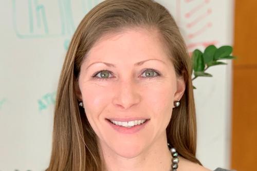 Headshot of Heather Christofk. She is wearing a grey top and smiling.