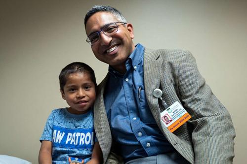 Dr. Manish Butte with Abraham Gonzalez-Martinez, who at age 4 was treated for a case of disseminated coccidioidomycosis.