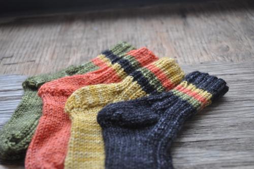 four different-colored knit socks