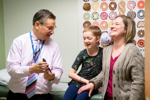 UCLA’s Dr. Donald Kohn with Marley Gaskins and her mother, Tamara Hogue. The group is photographed in a UCLA hospital room. 