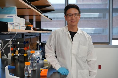 Dr. Chen Yuan Kam, posing in front of his laboratory.