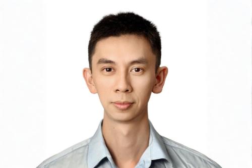 A headshot of UCLA researcher Hao Zhang, M.D. He wears a grey shirt and stands before a plain white background.