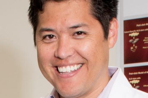 Headshot of smiling man with brown hair