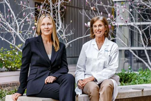 Amander Clark and Beth Karlan seated on a UCLA bench.