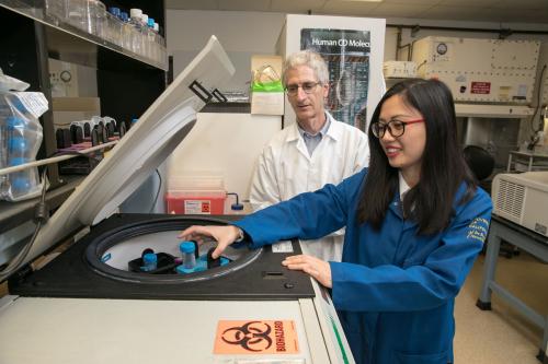 Ken Dorshkind stands alongside a trainee at work in a UCLA lab.