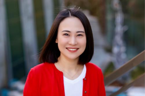 headshot of scientist mingxia gu wearing a white shirt and red cardigan