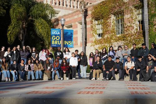 dozens of high school students sitting down in the campus center of ucla