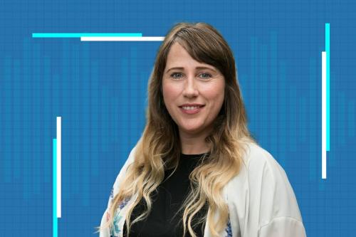 siobhan braybrook in a white sweater against a blue grid background