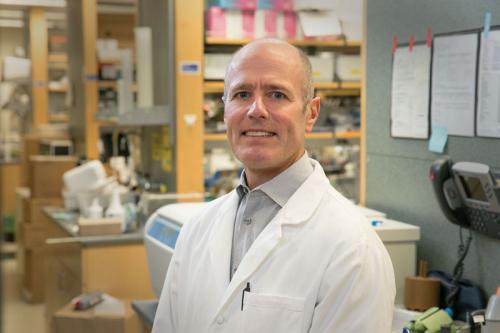 Headshot of S. Thomas Carmichael in a lab coat