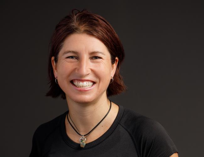 headshot of smiling woman with short brown hair