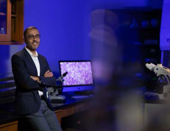 Dr. Mina Sedrak smiles in a UCLA laboratory. 