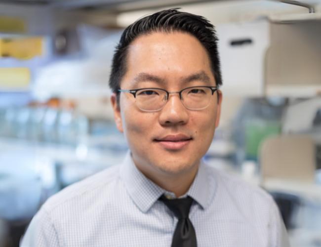 A man in a UCLA lab smiles into the camera.