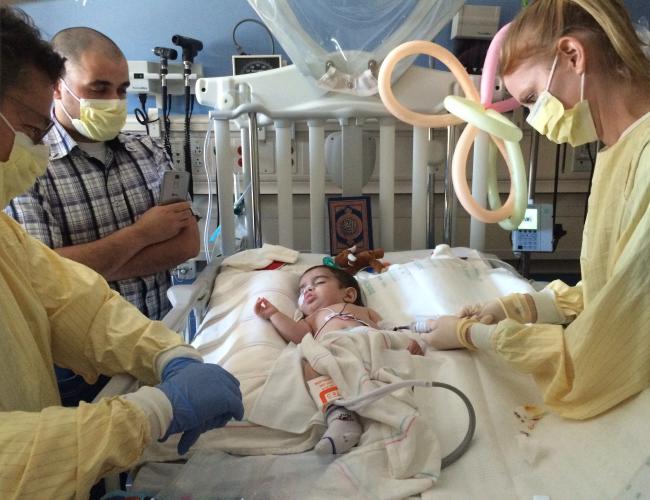 Hussein El Kerdi during his 2016 procedure at UCLA. His father, Ali El Kerdi (with cell phone) looks on.