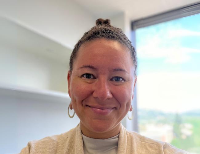 Researcher Tiki Hayes smiles for a headshot in her office