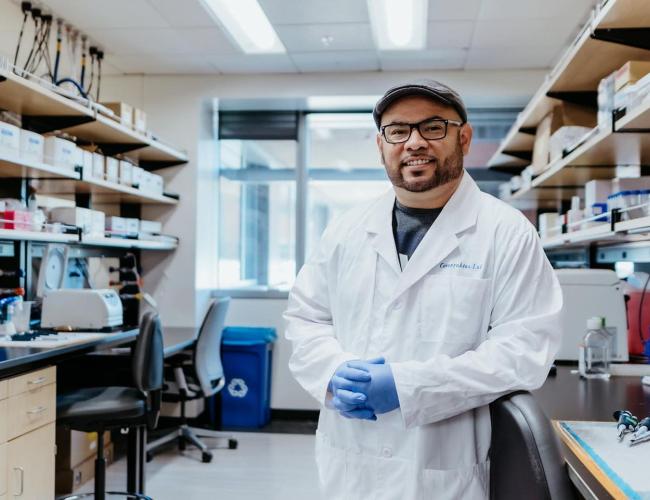 Anthony Covarrubias smiles in a UCLA laboratory. 