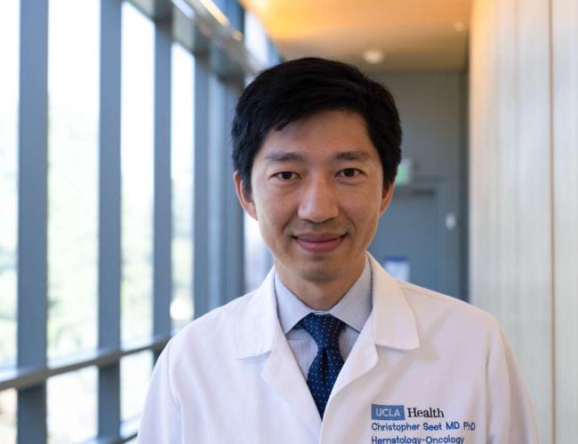 Christopher Seet smiles in a UCLA hallway.