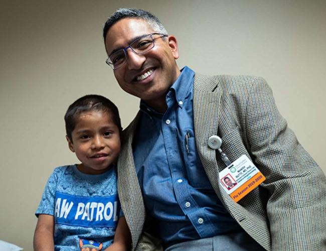 Dr. Manish Butte with Abraham Gonzalez-Martinez, who at age 4 was treated for a case of disseminated coccidioidomycosis.