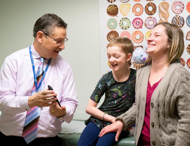 UCLA’s Dr. Donald Kohn with Marley Gaskins and her mother, Tamara Hogue. The group is photographed in a UCLA hospital room. 