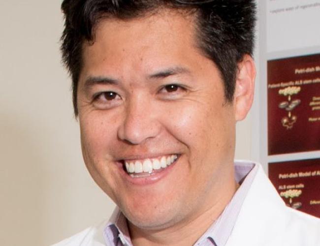 Headshot of smiling man with brown hair