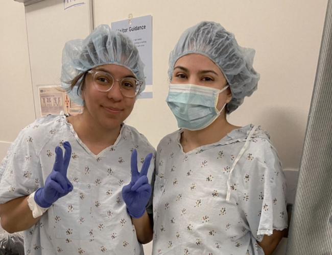 Two sisters in hospital gowns and 