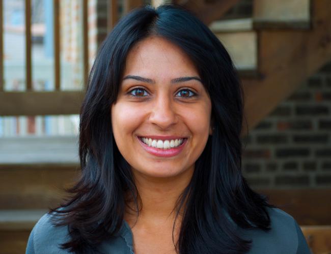 photo of smiling woman with longer than shoulder length black hair