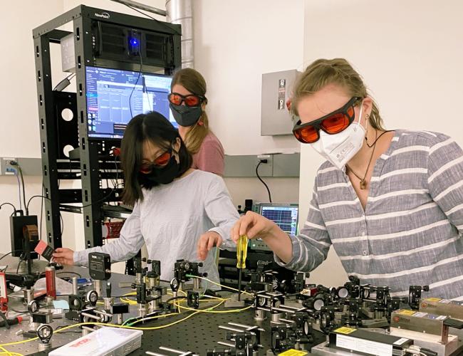 Ph.D. students Brittany Lu, post-doc Ana Valdes-Curiel and Ph.D student Vanessa Scheller collaborate in the Quantum Biology Tech lab led by Clarice Aiello