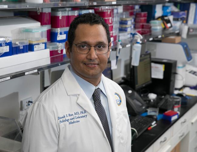 Headshot of Dinesh Rao in lab coat