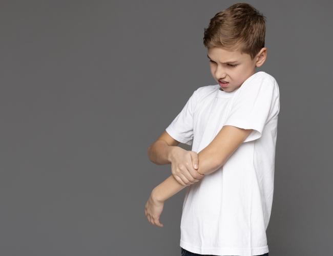 Child grabs elbow.