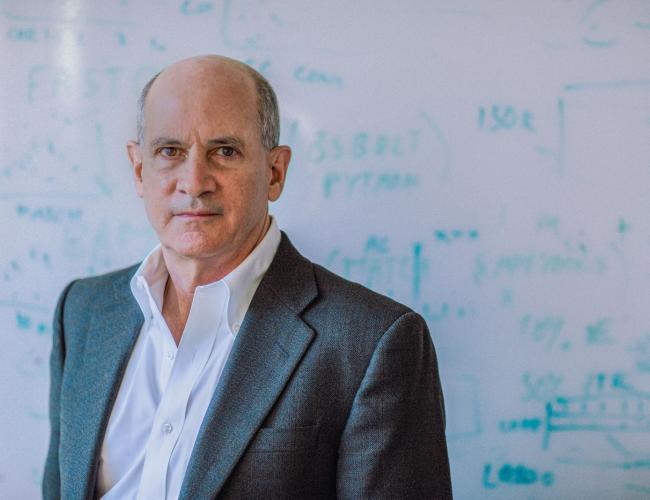 Headshot of Thomas Rando in front of a whiteboard