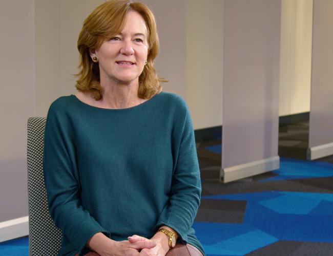 Headshot of Gay Crooks in a blue sweater