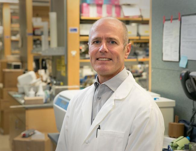 Headshot of S. Thomas Carmichael in a lab wearing a lab coat