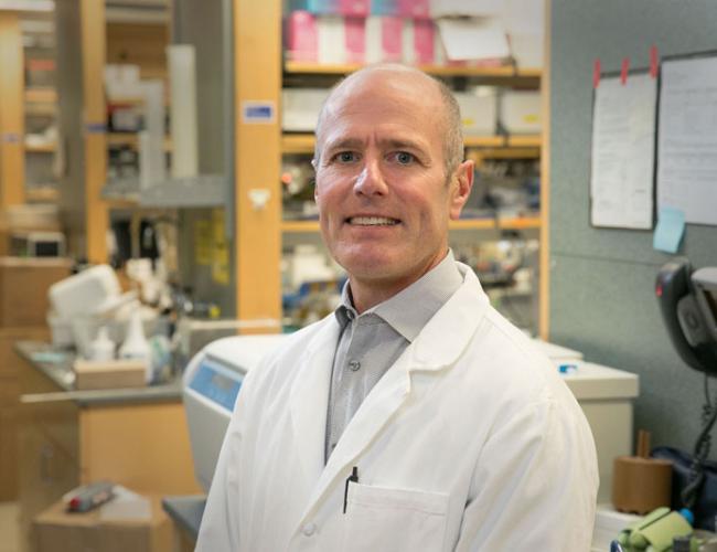 Headshot of S. Thomas Carmichael in a lab coat