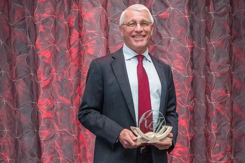 Dr. Owen Witte holding alumni award.