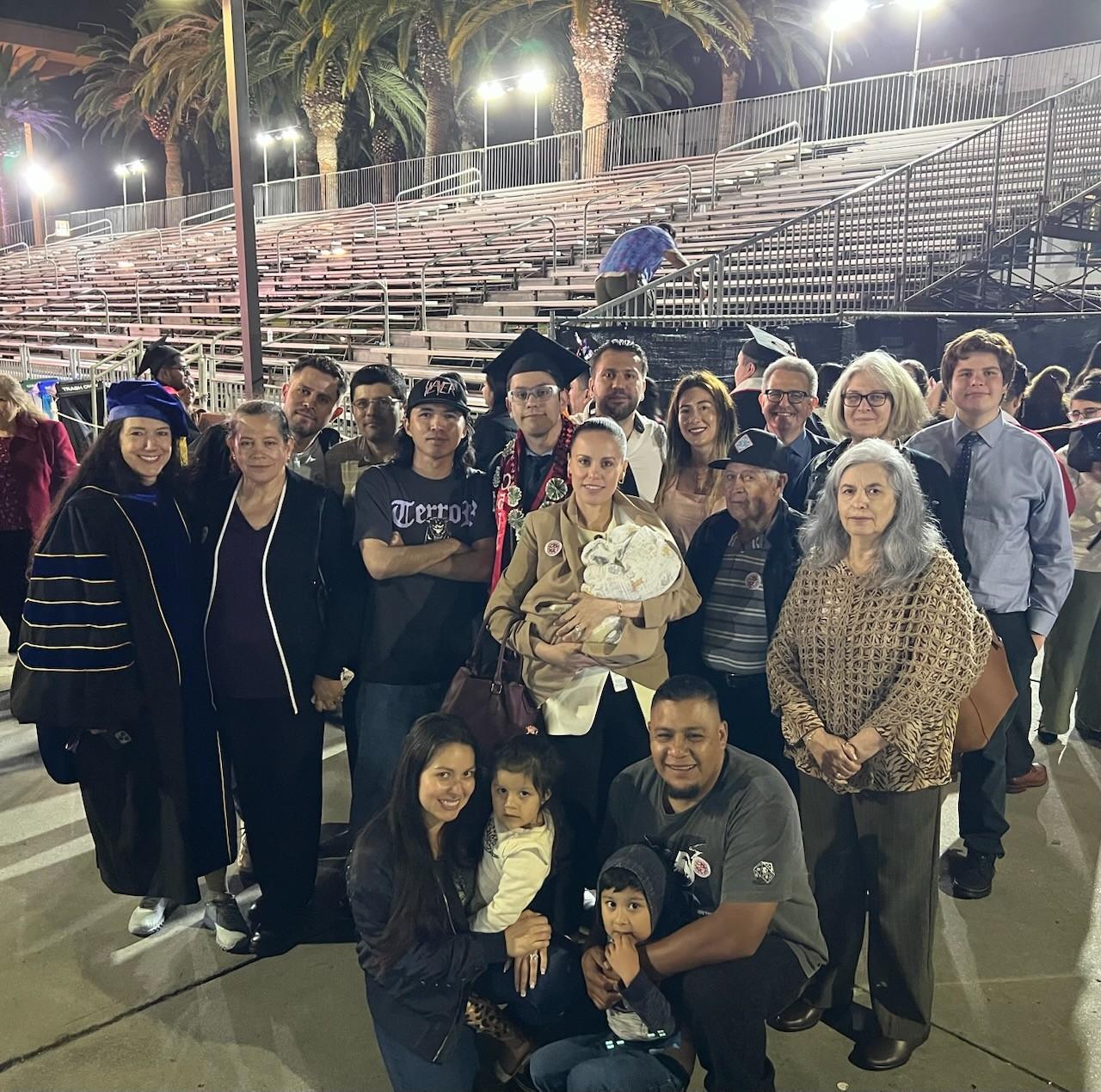 Group photo of Cristian Rodriguez at his college graduation with family and mentors