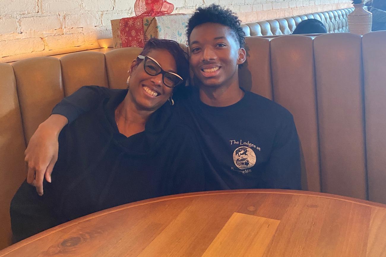 Shyra and Jaren Smith smile in a restaurant booth together.